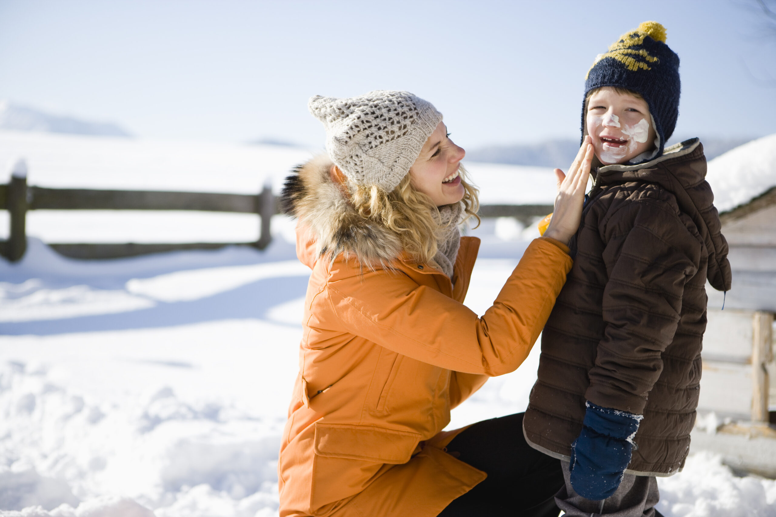 Mother,Applying,Sunscreen,To,Son